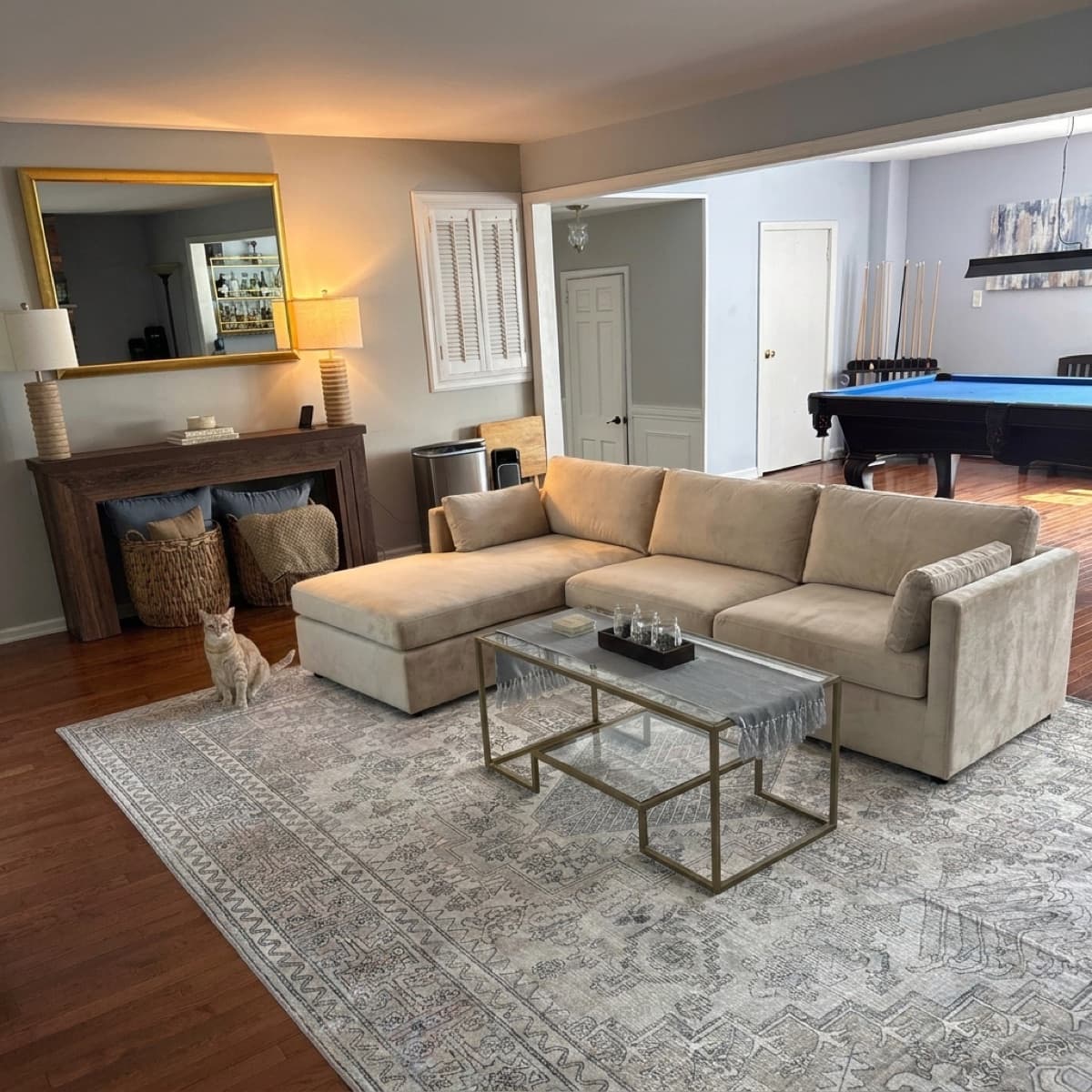 AI concept render of the sectional viewed from the fireplace toward the console and billiards room